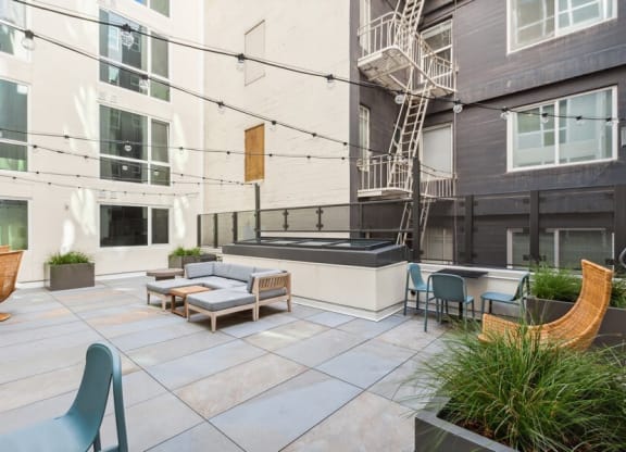 Outdoor lounge space with furniture at TL Residences