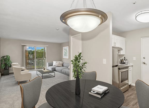 Model dining area with a table and chairs at Stone Ends apartments in Stoughton, MA