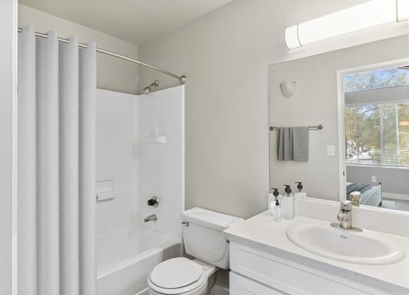 Model Bathroom with White Cabinets and Shower/Tub at Meadow Ridge Apartments in Las Vegas, NV.