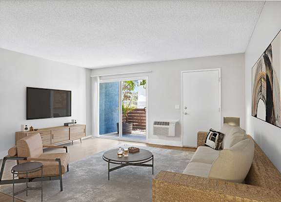 Model Living Room with Wood-Style Flooring and Patio Accessibility at Cove La Mesa Apartments located in La Mesa, CA.