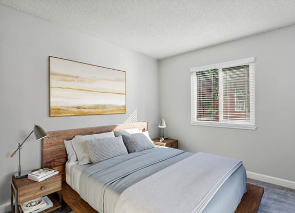 Model Bedroom with Carpet and Window View at The Archer Apartments in Sacramento, CA.