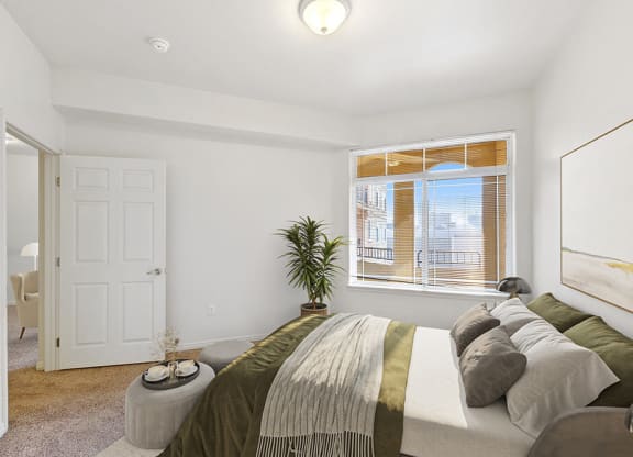 Model Bedroom with Carpet and Window View at Altitude on Fifth Apartments in Salt Lake City, UT.