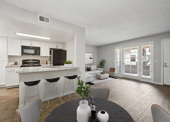 Model Dining Room and Kitchen with Wood-Style Flooring at Country Club Verandas Apartments located in Mesa, AZ.