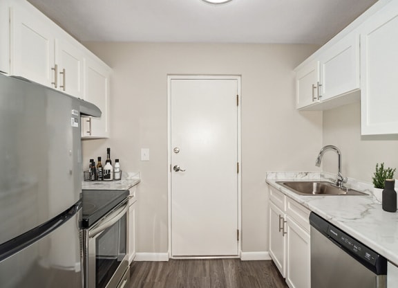 Mode kitchen with white cabinets and stainless steel appliances  at Stone Ends apartments in Stoughton, MA