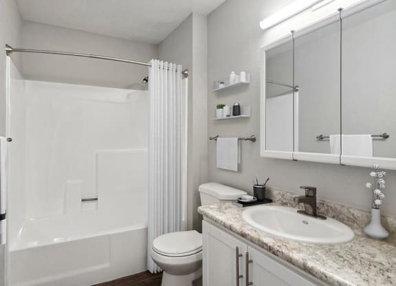 Model Bathroom with White Cabinets, Wood-Style Flooring and Shower/Tub at Overlook Point Apartments in Salt Lake City, UT.