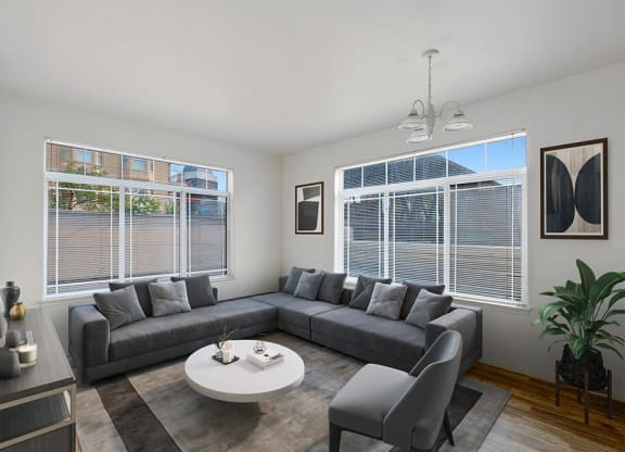 Model Living Room with Wood-Style Flooring and Window View at Altitude on Fifth Apartments in Salt Lake City, UT.