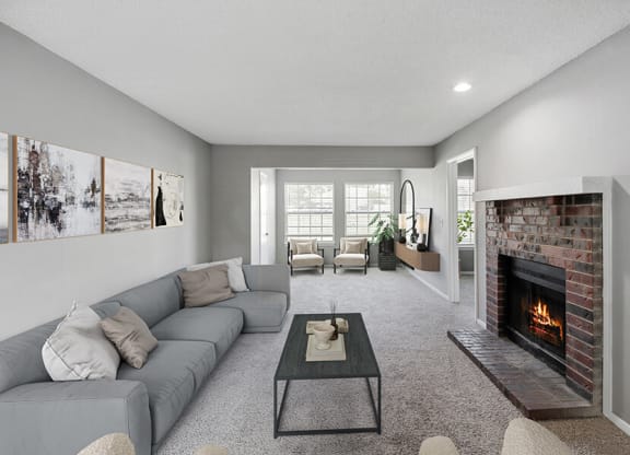 Model Living Room with Carpet and Fireplace at Abbington Heights Apartments in Antioch, TN.