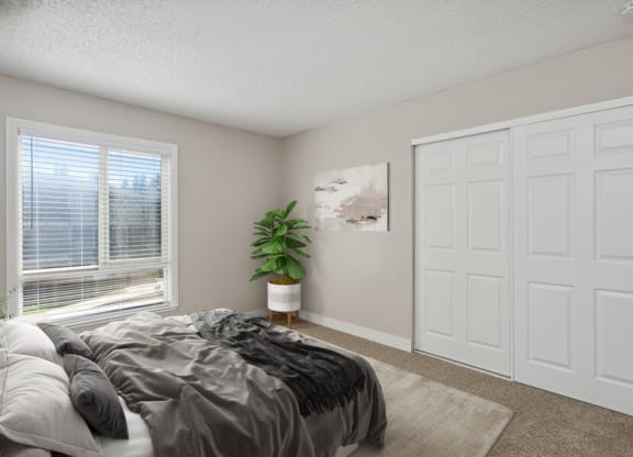 Model bedroom with a bed and a window