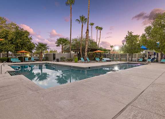 Community Swimming Pool with Pool Furniture at Lakeside Casitas Apartments located in Tucson, AZ.