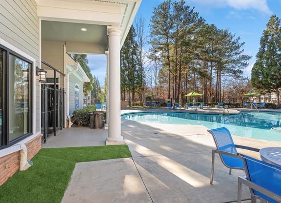 Community Swimming Pool with Pool Furniture at Shadow Ridge Apartments in Riverdale, GA.