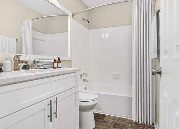 Model Bathroom with White Cabinets, Wood-Style Flooring and Shower/Tub at Element 41 Apartments located in Marietta, GA.