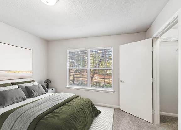 Model Living Room with Carpet and Walk In Closet at Lake Cameron Apartments located in Apex, NC.