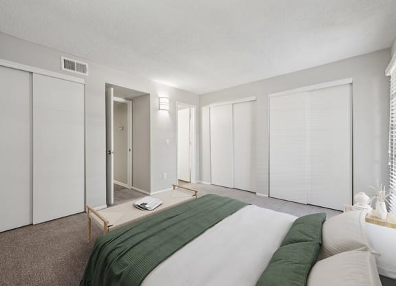 Model Bedroom with Carpet and Window View at Country Club Verandas Apartments located in Mesa, AZ.