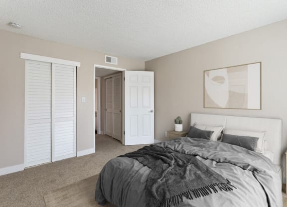 Model bedroom with a bed and a closet