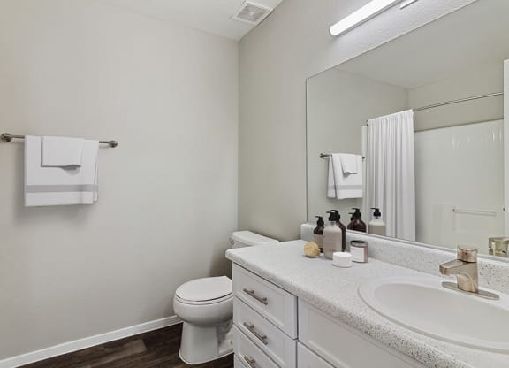 Model Bathroom with Wood-Style Flooring at Verraso Apartments in Las Vegas, NV.