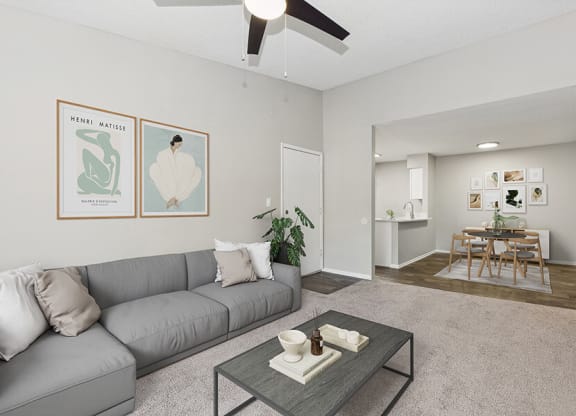 Model Living Room with Carpet and View of Kitchen/Dining Area at Grand Pavilion Apartments in Tampa, FL.