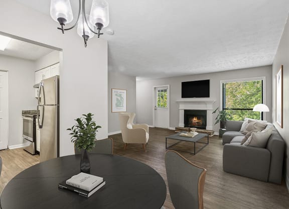 Model Dining Room with Wood-Style Flooring and View of Living Room at Lakeside Retreat Apartments located in Peachtree Corners, GA.