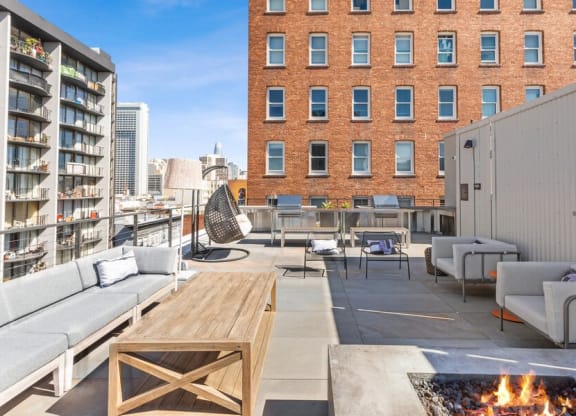 Rooftop lounge space with fire pit at TL Residences