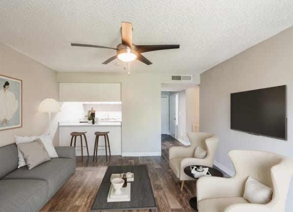 Model Living Room with TV and View of Kitchen at Indigo Park Apartments in Albuquerque, NM.