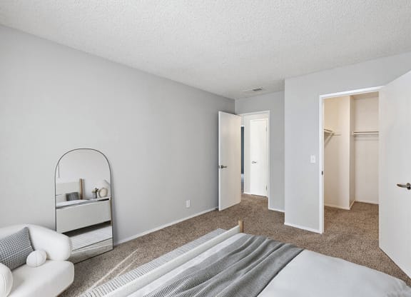 Model Bedroom with Carpet and Walk In Closet at Bridges on Sunset Apartments in Suisun City, CA.