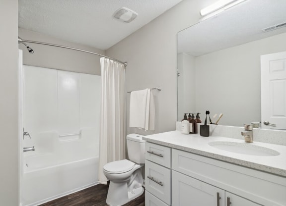 Model bathroom with tub and shower at Retreat at Stonecrest Apartments