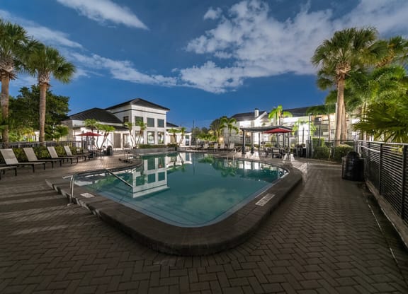 Community Swimming Pool with Pool Furniture at Rosehill Preserve Apartments located in Orlando, FL.