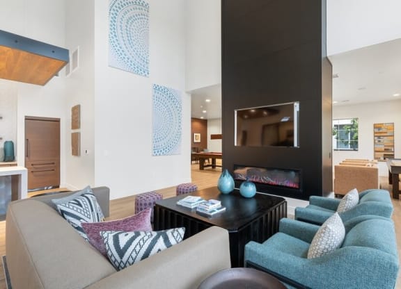 Community lounge area with fireplace and tv
