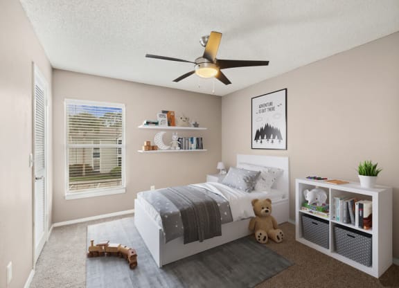 Model bedroom with a bed and a ceiling fan at Vue at Baymeadows Apartments in Jacksonville, Florida