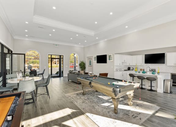 Community Clubhouse with Lounge Furniture and Game Tables at Shadow Ridge Apartments in Riverdale, GA.