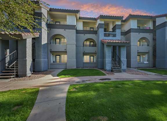 Sunset view of Stillwater apartment buildings with a courtyard in the foreground.