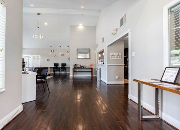 A modern living room with dark wood floors and white walls.