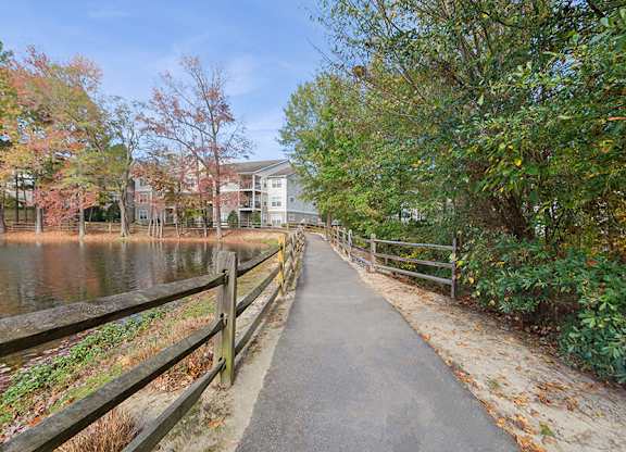 Community Walking Path and Lake at Lake Cameron Apartments located in Apex, NC.