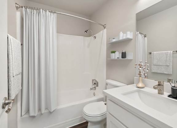 Model Bathroom with White Cabinets, Wood-Style Flooring & Shower/Tub at Walnut Creek Apartments located in Walnut Creek, CA.