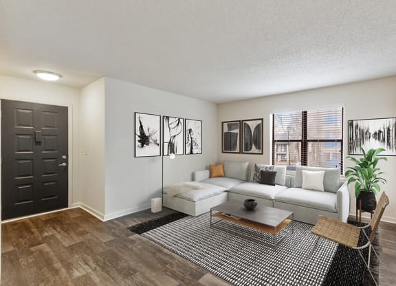 Model Living Room with Wood-Style Flooring and Patio Accessibility at Grandstand Apartments in Marietta, GA.