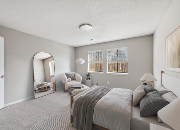 Model Bedroom with Carpet and Window View at Spring Forest Apartments in Raleigh, NC.