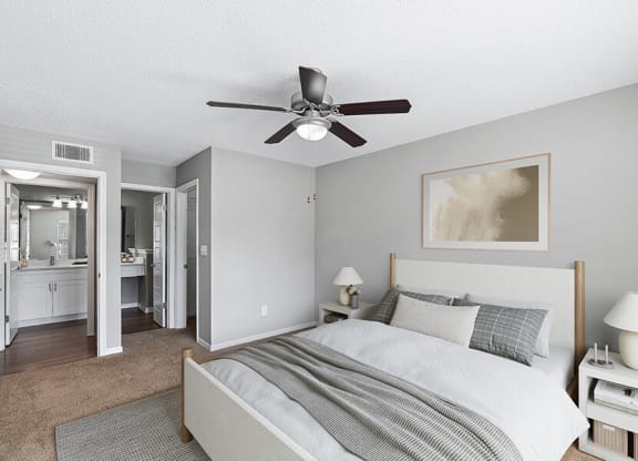 Model Bedroom with Carpet and attached Bathroom at Fountains Lee Vista Apartments in Orlando, FL.