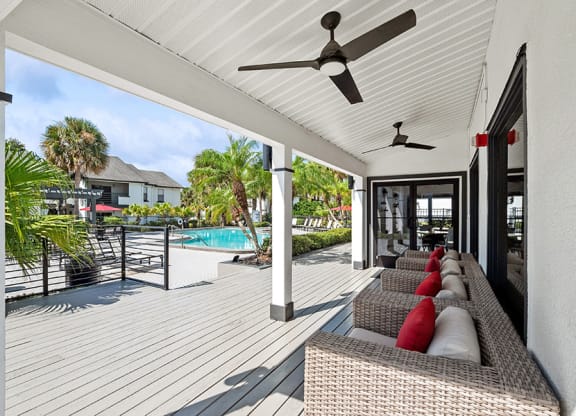 Outdoor Covered Patio with Furniture at Rosehill Preserve Apartments in Orlando, FL.