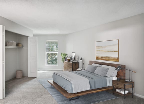 Model Bedroom with Carpet and Window View at Arbor Village Apartments located in Charlotte, NC.