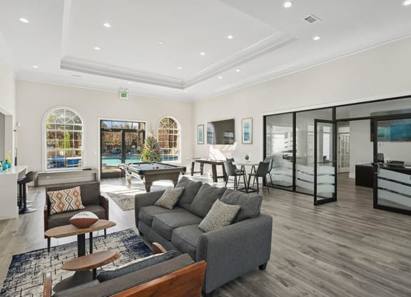 Community Clubhouse with Lounge Furniture and Game Tables at Shadow Ridge Apartments in Riverdale, GA.