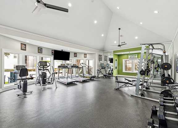 Community Fitness Center with Equipment at Bridges at Oakbend Apartments located in Lewisville, TX.