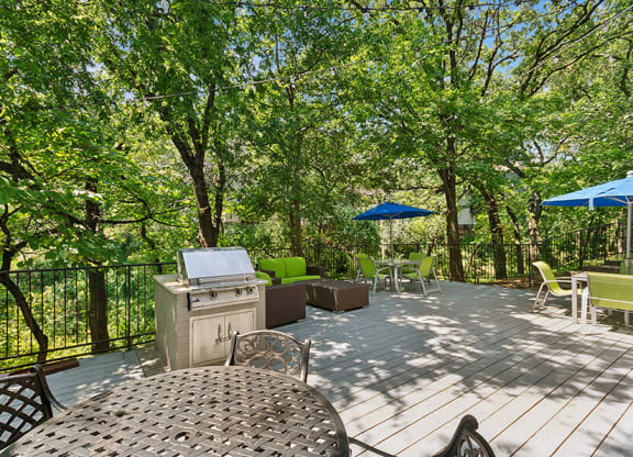 Outdoor Patio with Lounge Furniture & BBQ Grills at Woodcreek Apartments located in Arlington, TX.