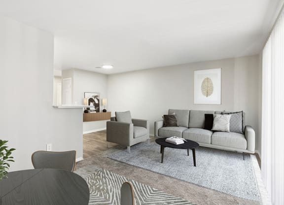 Model Living Room and Dining Room Area with Carpet at Loma Vista Apartments in Las Vegas, NV.