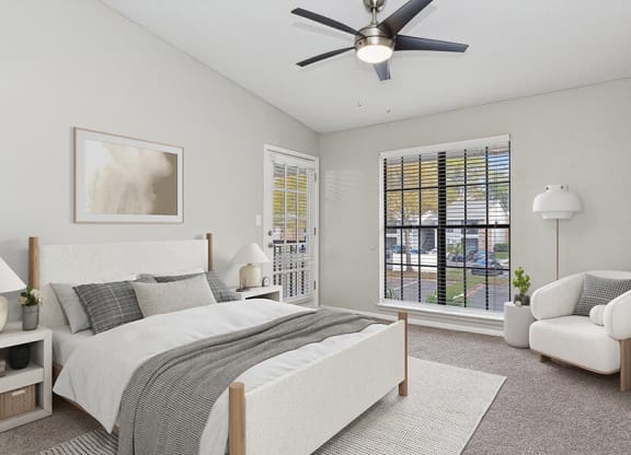 Model Bedroom with Carpet and Window View at Grand Pavilion Apartments in Tampa, FL.