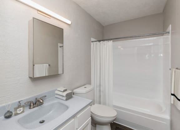 Model Bathroom with Wood-Style Flooring at Indigo Park Apartments in Albuquerque, NM.