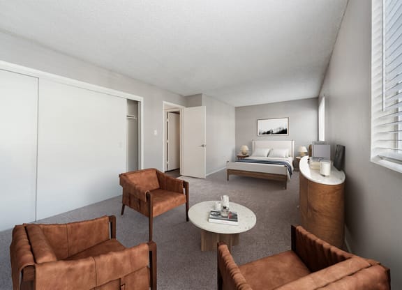 Model Living Room with Carpet, Double Closets and Window View at Bridges at 9 Mile Station Apartments in Denver, CO.