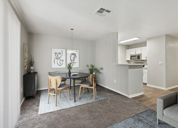 Model Dining Room and Kitchen Area with View of Living Room at Loma Vista Apartments in Las Vegas, NV.