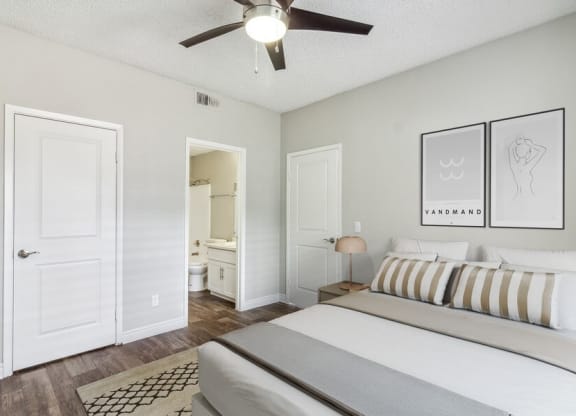 a bedroom with a bed and a ceiling fan