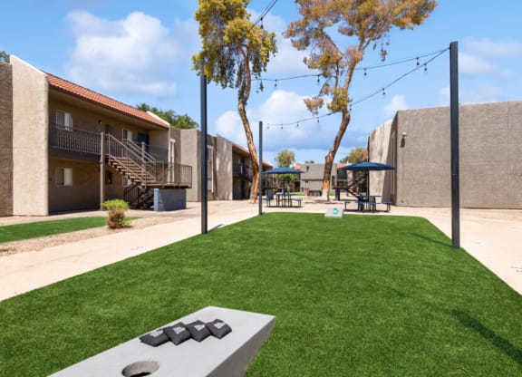 community cornhole area on artificial turf at Villages at Metro Center, Phoenix, 85051