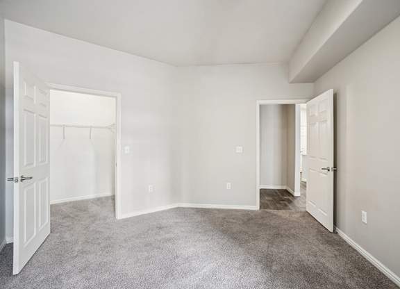 Model Bedroom with Carpet and Walk-In Closet at Altitude on Fifth Apartments located in Salt Lake City, UT.