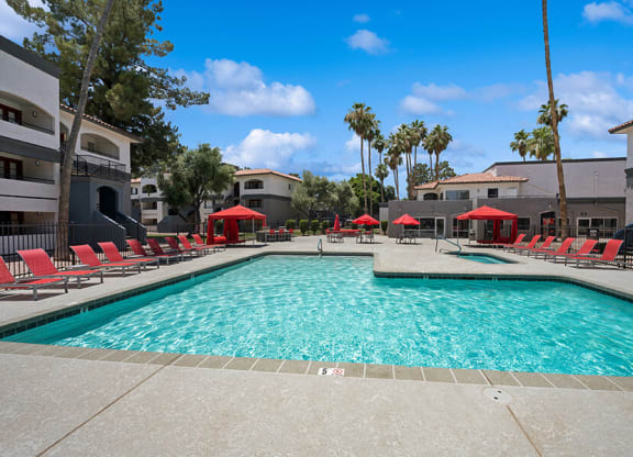 Community Swimming Pool with Pool Furniture at Country Club Verandas Apartments located in Mesa, AZ.